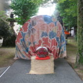 泉の祭りの象徴、赤獅子が参道に佇む